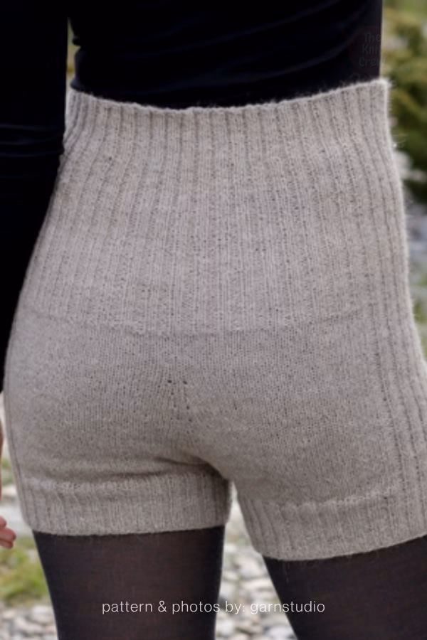 A back view of high-waisted, taupe-colored ribbed knitted adult shorts. Curated by Ariana of TheKnitCrew.