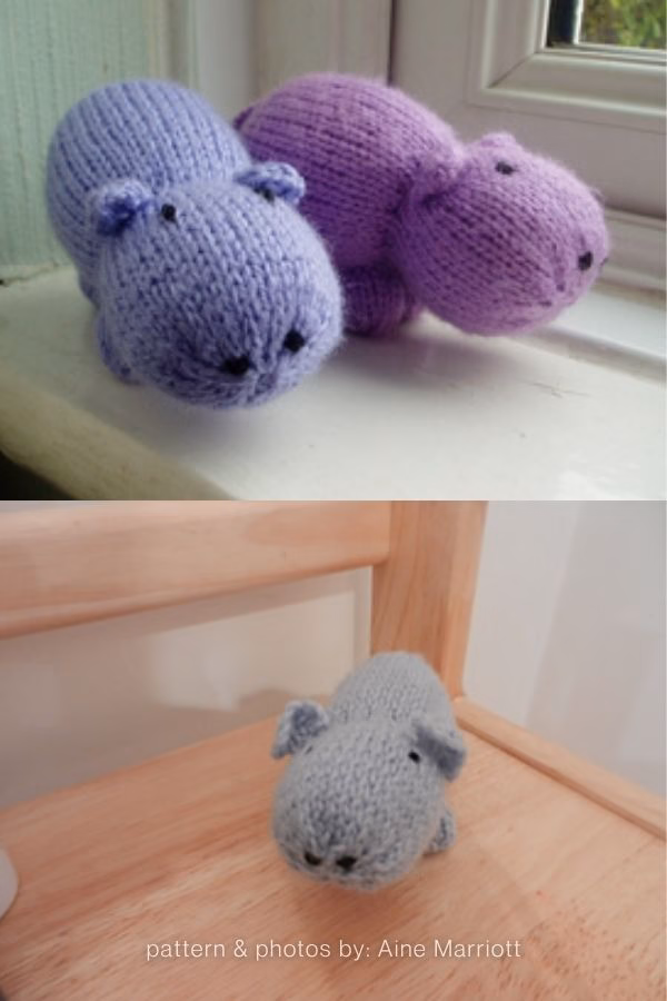 A split image featuring small, pill-shaped knitted hippo toys. The top half shows two hippos—one light purple and one dark purple—resting on a white windowsill. The bottom half shows a similar small grey hippo sitting on a light wooden surface. Text at the bottom reads "pattern & photos by: Aine Marriott". This is part of a knitting roundup from The Yarn Crew.