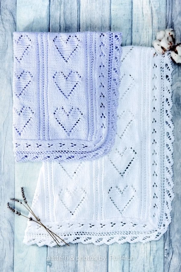 A lavender-purple knitted blanket folded over a matching white version, both showcasing repeating pointelle lace heart panels and detailed openwork borders. Text at the bottom reads: "pattern & photos by: Purl4fun". Curated by Ariana of TheKnitCrew.
